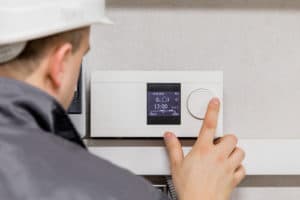 worker uses thermostat