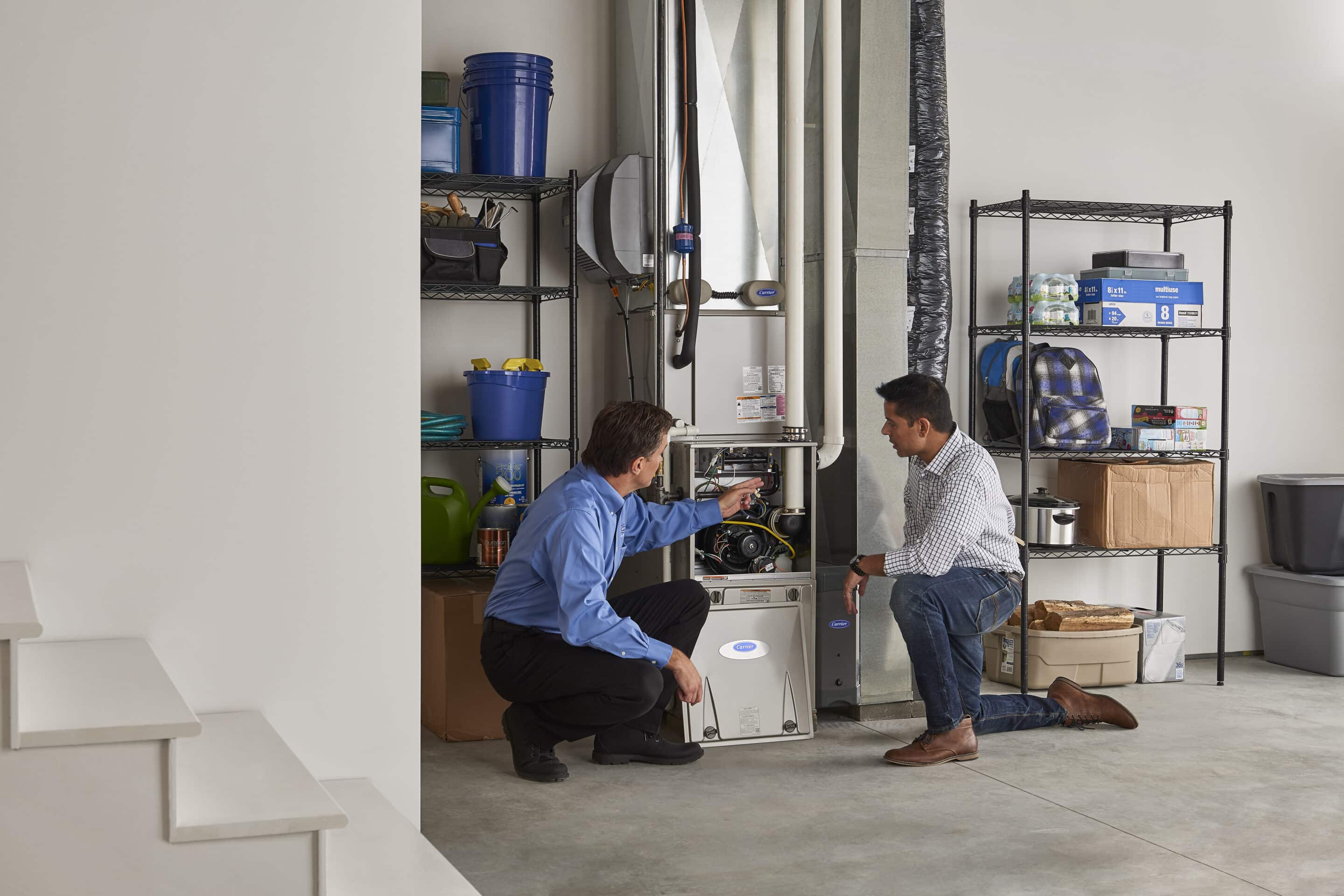 HVAC technician explaining a newly installed Carrier furnace to the homeowner. 