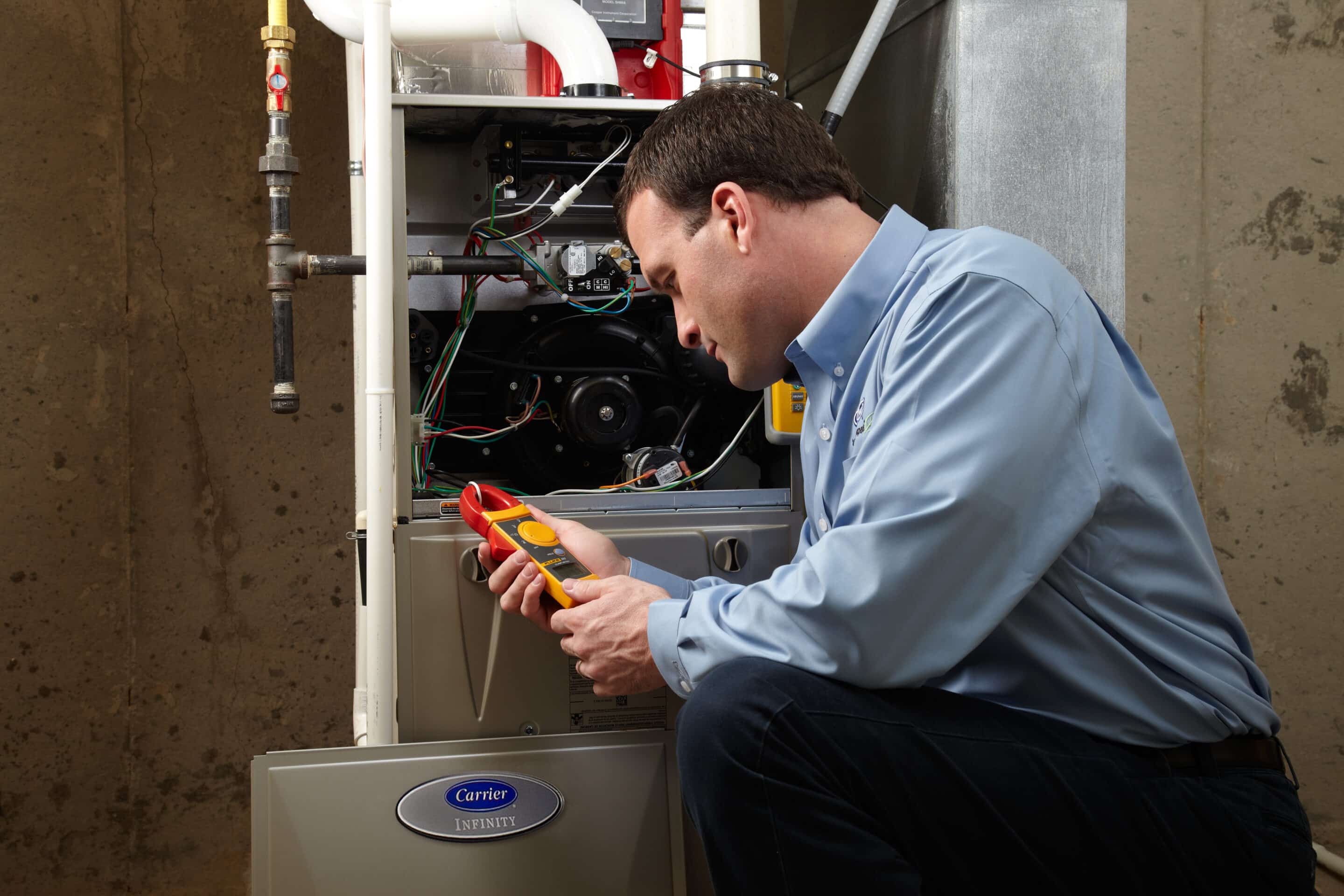 Service technician repairing a Carrier furnace and getting fixed for the client. 