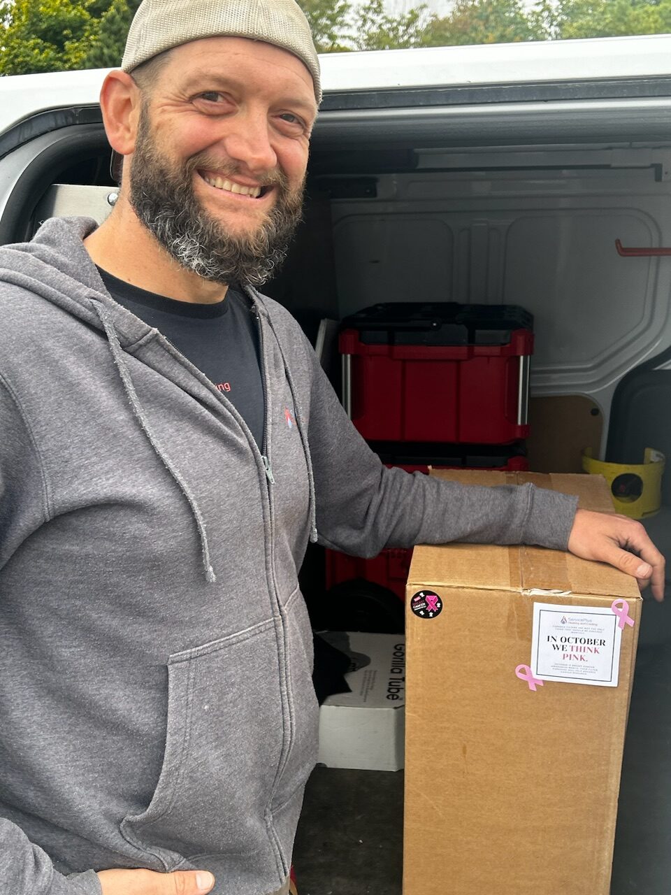 Our technician Jordan putting furnace filters in his truck for the breast cancer campaign. 